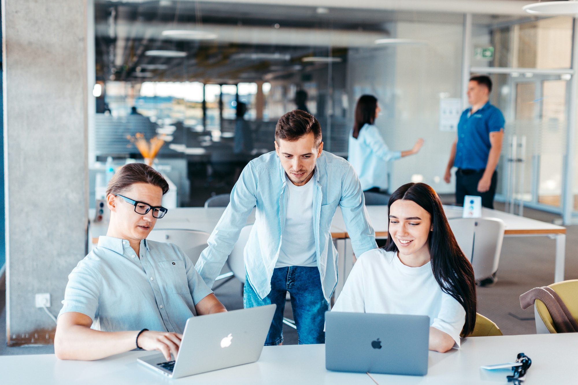 A team discussing a marketing plan together around a laptop