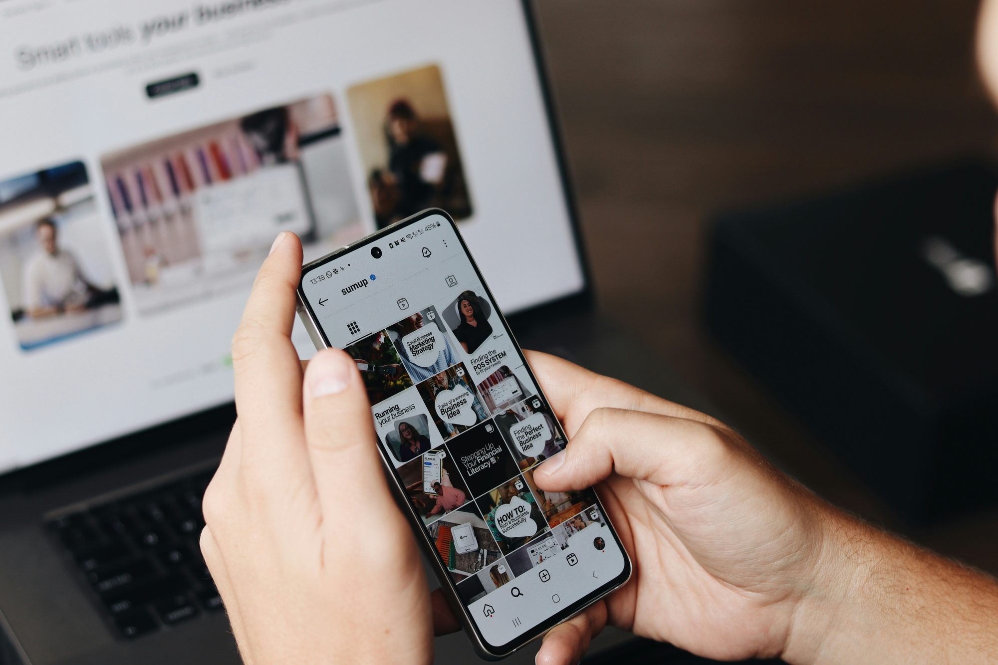 Close-up of a phone showing a social media feed being managed