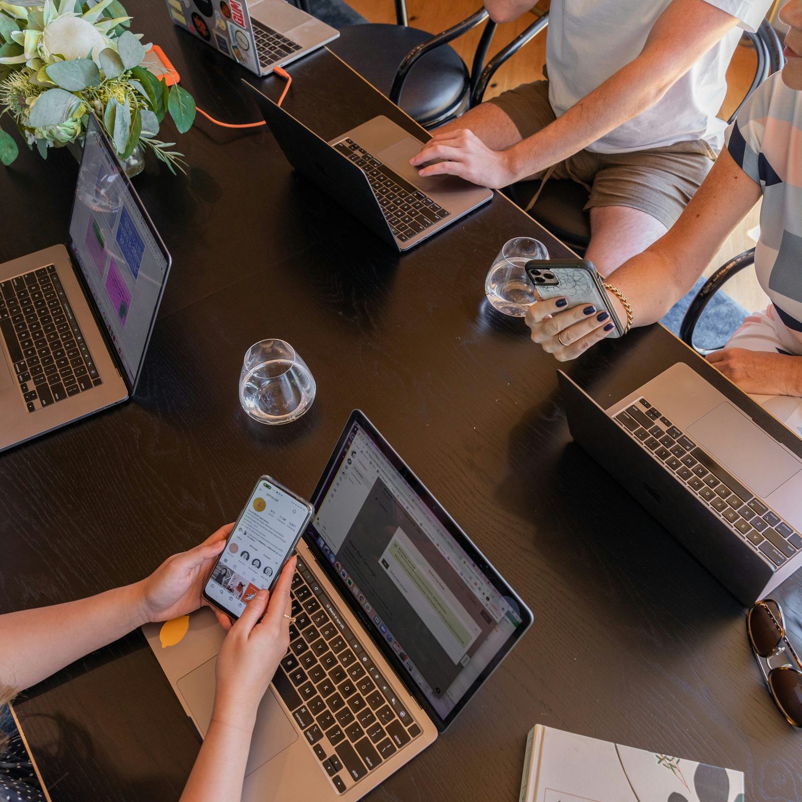 A marketing team collaborating over laptops, planning a digital strategy
